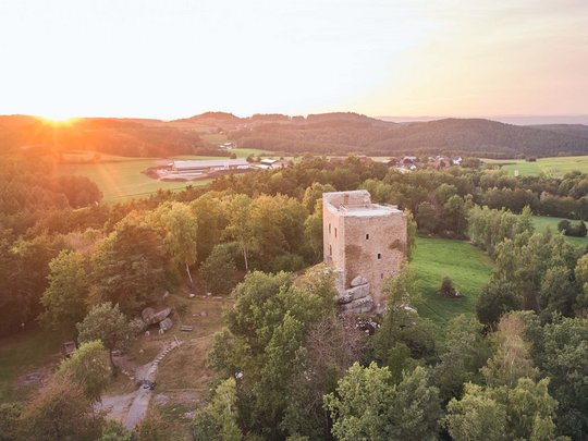 Sehenswertes rund ums Wellnesshotel Luftaufnahme der Burgruine Lobenstein bei Sonnenuntergang im Bayerischen Wald nahe Cham – beliebtes Ausflugsziel in der Umgebung des Wellnesshotel Randsbergerhof in der Oberpfalz.